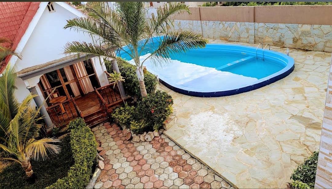 Swimming pool and garden at Afro Queen Hotel